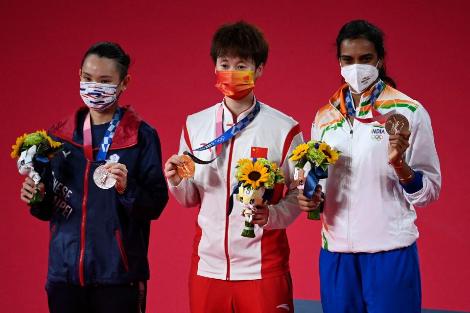 China's Chen Yufei (C) poses with her women's singles badminton gold medal with Taiwan's Tai Tzu-ying (L) with her silver medal and India's P. V. Sindhu with her bronze medal at a ceremony during the Tokyo 2020 Olympic Games at the Musashino Forest Sports Plaza in Tokyo on August 1, 2021. (Photo by Alexander NEMENOV / AFP) (Photo by ALEXANDER NEMENOV/AFP via Getty Images)