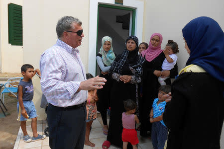 Nampil-iosif Morant, the Syrian-born mayor of the local Andravida-Kyllini municipality, meets Syrian refugees in a former Peloponnese tourist resort that has been turned into a migrant home near the town of Myrsini southwest of Athens, Greece, August 13, 2016. Picture taken August 13, 2016. REUTERS/Michele Kambas