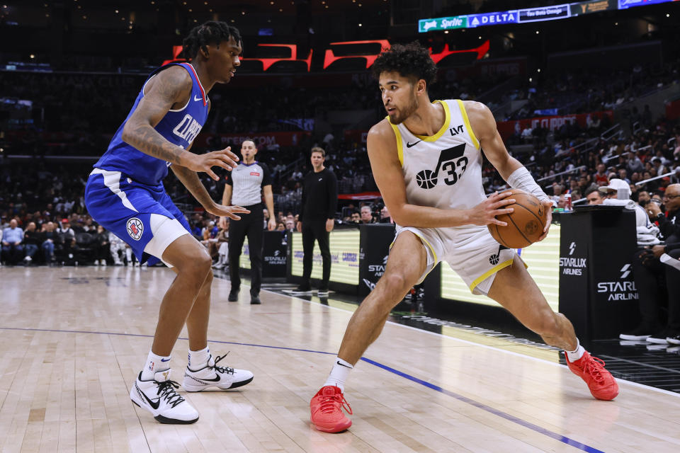 Utah Jazz guard Johnny Juzang, right, is defended by Los Angeles Clippers guard Bones Hyland during the second half of an NBA basketball game Friday, April 5, 2024, in Los Angeles. (AP Photo/Etienne Laurent)