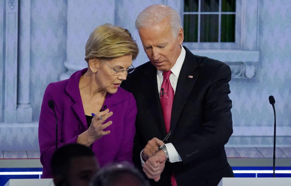 Democratic presidential candidate and Senator Elizabeth Warren and former Vice President Joe Biden look at his watch during a break at the fifth 2020 campaign debate at the Tyler Perry Studios in Atlanta, Georgia, U.S., November 20, 2019. REUTERS/Brendan McDermid     TPX IMAGES OF THE DAY