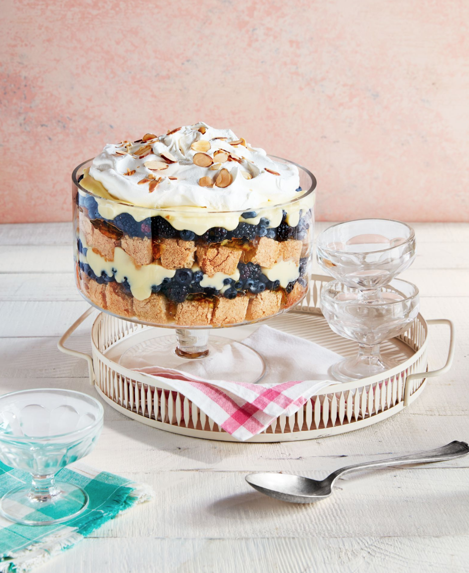 fruit and nut trifle in a glass trifle dish with serving cups to the side