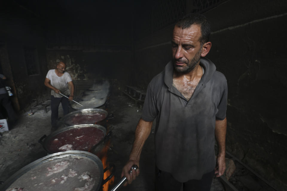 Palestinians cook food for people displaced in the ongoing Israeli bombardment of the Gaza Strip in Rafah on Saturday, Oct. 28, 2023.AP Photo/Hatem Ali)