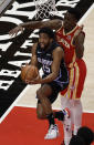 Orlando Magic guard Chasson Randle (25) shoots against Atlanta Hawks' Onyeka Okongwu, right, in the first half of an NBA basketball game Tuesday, April 20, 2021, in Atlanta. (AP Photo/Ben Margot)