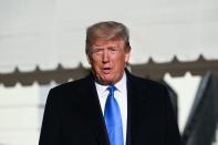 U.S. President Donald Trump speaks to reporters before departing the White House en route to Florida