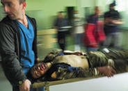 FILE In this file photo taken on Wednesday, Oct. 28, 2020, Medical workers transport a wounded in a hospital during shelling by Azerbaijan's artillery in Stepanakert, the separatist region of Nagorno-Karabakh, Wednesday, Oct. 28, 2020. Nagorno-Karabakh officials said Azerbaijani forces hit Stepanakert, the region's capital, and the nearby town of Shushi with the Smerch long-range multiple rocket systems, killing one civilian and wounding two more. (AP Photo/Dmitri Lovetsky, File)