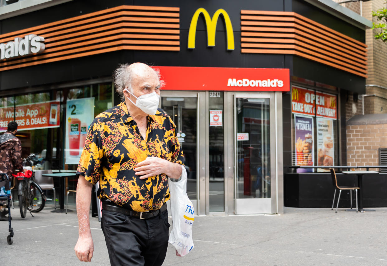 A person wears a face mask outside McDonald's on the Upper West Side on May 28, 2021 in New York City. On May 19, all pandemic restrictions, including mask mandates, social distancing guidelines, venue capacities and restaurant curfews were lifted by New York Governor Andrew Cuomo. (Noam Galai/Getty Images)