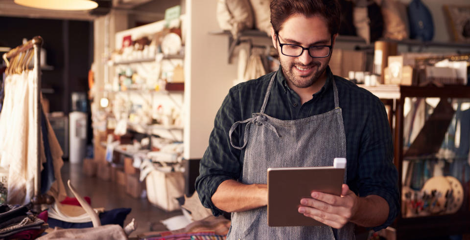 artist in apron on tablet