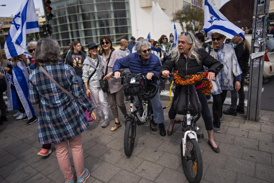 Israeli "grandmothers for democracy" protest plans by Prime Minister Benjamin Netanyahu's government to overhaul the judicial system, saying the planned reform is worrying for the future of the country, in Tel Aviv, Israel, Wednesday, March 22, 2023. (AP Photo/Oded Balilty)