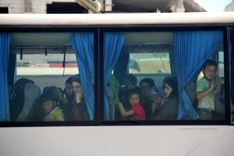 Syrian civilians being evacuated from the government-held towns of Fuaa and Kafraya, which have been under crippling siege for more than two years, near the rebel-held transit point of Rashidin on April 19, 2017