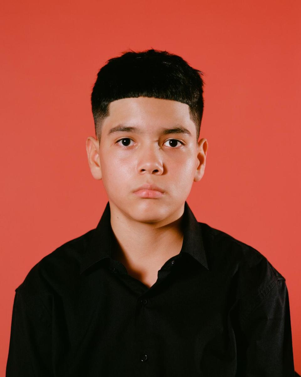 Image of a boy wearing an Edgar haircut, looking straight at the camera.