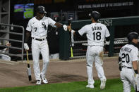 Chicago White Sox's Ryan Goins (18) celebrates with teammate Tim Anderson (7) after scoring on a Nomar Mazara single during the eighth inning of a baseball game against the Detroit Tigers Tuesday, Aug. 18, 2020, in Chicago. (AP Photo/Paul Beaty)