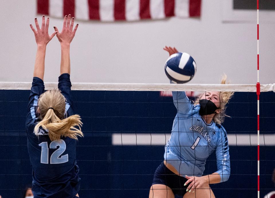 Central Valley Christian's Grace Van Der Kooi hits past Redwood's Audrey Hyde in a Central Section Division I playoff game on Thursday, October 28, 2021. 