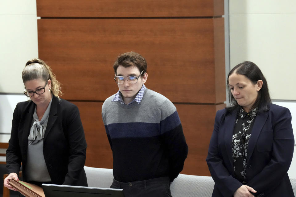 Marjory Stoneman Douglas High School shooter Nikolas Cruz, center, stands with members of his defense team as the jury enters the courtroom during the penalty phase of his trial at the Broward County Courthouse in Fort Lauderdale, Fla., on Monday, Sept. 12, 2022. Cruz pleaded guilty to murdering 17 students and staff members in 2018 at Parkland's high school. The trial is only to determine if the 23-year-old is sentenced to death or life without parole. (Amy Beth Bennett/South Florida Sun-Sentinel via AP, Pool)