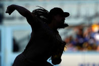 San Diego Padres starting pitcher Mike Clevinger is silhouetted as he throws to the plate during the first inning of a baseball game against the Los Angeles Dodgers Saturday, Aug. 6, 2022, in Los Angeles. (AP Photo/Mark J. Terrill)