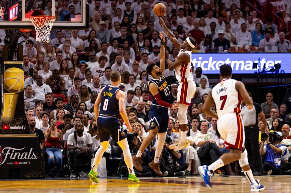 Miami Heat forward Jimmy Butler (22) shoots over Denver Nuggets guard Jamal Murray (27) during the first half of Game 4 of the NBA Finals at the Kaseya Center on Friday, June 9, 2023, in downtown Miami, Fla.