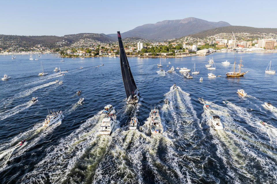 In a photo provided by Role, Comanche, center, is surrounded by spectator craft on arrival to Hobart, Australia, to claim victory in the Sydney to Hobart yacht race Saturday, Dec. 28, 2019. (Carlo Borlenghi/Rolex via AP)
