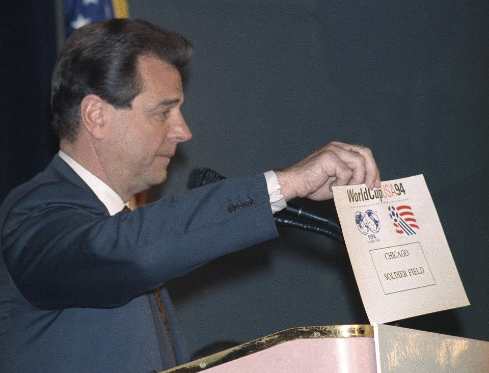 FILE - Alan I. Rothenberg, chairman, president and CEO of World Cup USA 1994, holds up a card reading "Chicago Soldier Field," at a news conference in New York, March 23, 1992, where the nine sites for soccer's 1994 World Cup were announced. As FIFA prepares to announce the 2026 World Cup sites on Thursday — and make high-profile cuts — Alan Rothenberg thought back to when stadiums were picked for the 1994 tournament he headed in the United States. (AP Photo/Osamu Honda, File)