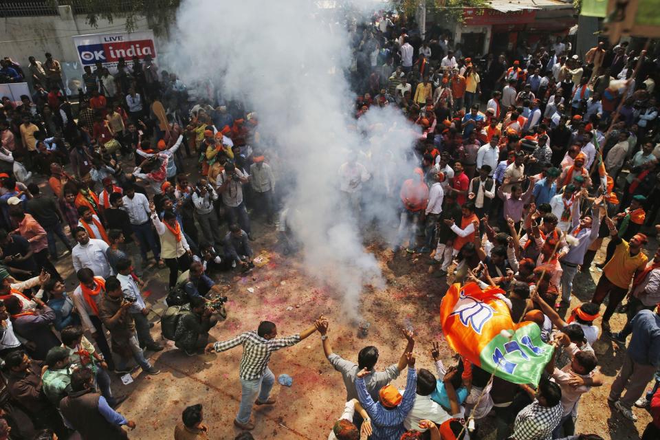 Bharatiya Janata Party supporters celebrate winning seats in the Uttar Pradesh state legislature elections in, Lucknow, India, Saturday, March 11, 2017. India's governing Hindu nationalist party was heading for major victories Saturday in key state legislature elections that are seen as a referendum on the performance of Prime Minister Narendra Modi's nearly 3-year-old government. (AP Photo/Rajesh Kumar Singh)