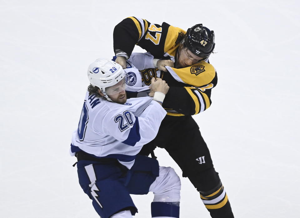 Tampa Bay Lightning center Blake Coleman (20) fights Boston Bruins defenseman Torey Krug (47) during the first period of an NHL hockey playoff game Wednesday, Aug. 5, 2020 in Toronto. (Nathan Denette/The Canadian Press via AP)