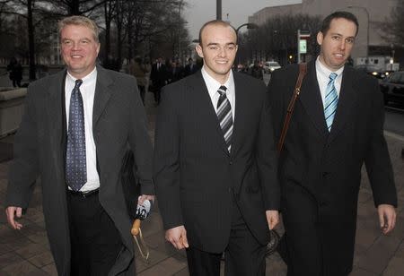 Blackwater Worldwide security guard Nick Slatten (C) leaves the federal courthouse with attorneys after being arraigned on manslaughter charges for allegedly killing 14 unarmed civilians and wounding 20 others in a 2007 Baghdad shooting, in Washington in this January 6, 2009 file photo. REUTERS/Jonathan Ernst/Files