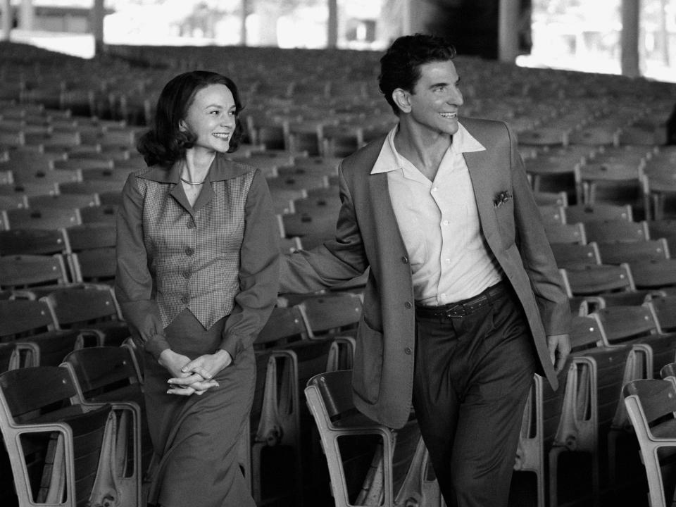 This image released by Netflix shows Carey Mulligan as Felicia Montealegre, left, and Bradley Cooper as Leonard Bernstein in a scene from "Maestro." (Jason McDonald/Netflix via AP)