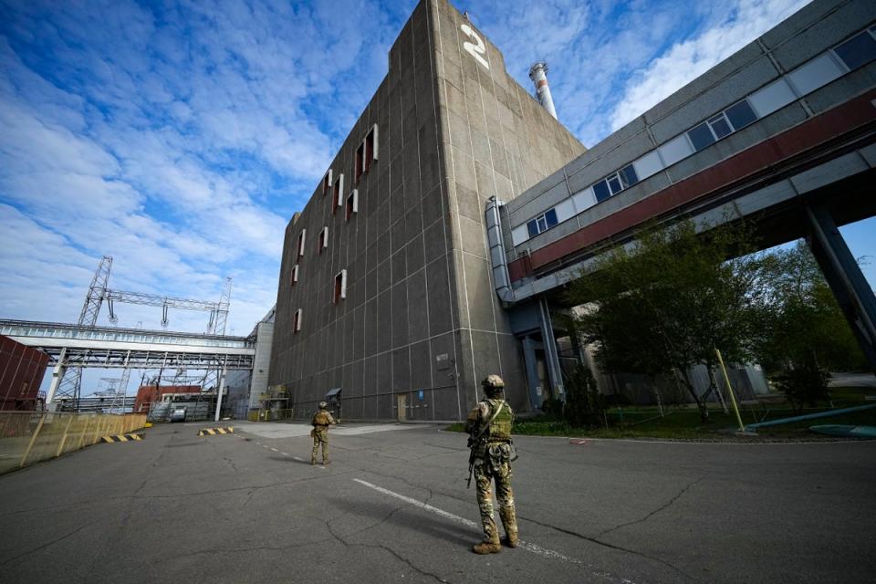 FILE - Russian servicemen guard an area of the Zaporizhzhia Nuclear Power Station, (AP)