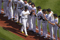 Pittsburgh Pirates' Ke'Bryan Hayes, center, is introduced before the Pirates' home-opener baseball game against the Chicago Cubs in Pittsburgh, Tuesday, April 12, 2022. (AP Photo/Gene J. Puskar)