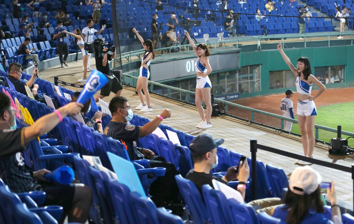 Fans cheer with cheerleaders at Xinzhuang Baseball Stadium in New Taipei City, Taiwan on May 8, 2020.