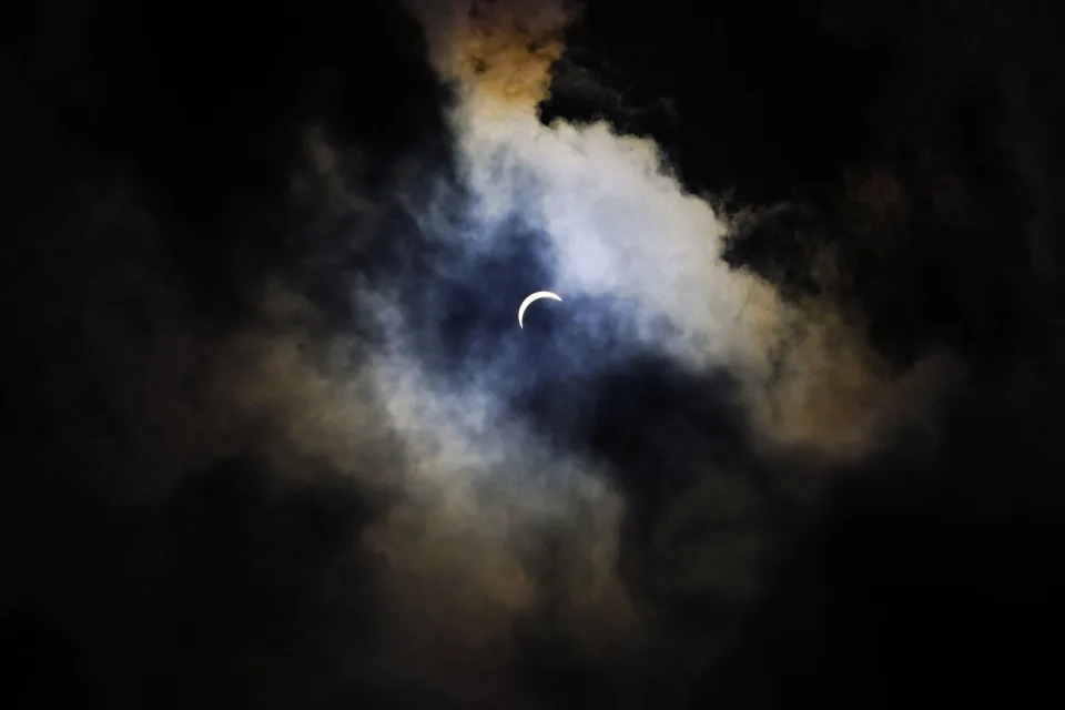 Clouds cover the eclipse in Arlington, Texas. (Julio Cortez / AP)