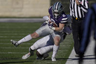 Kansas State running back Harry Trotter (2) is tackled by Texas linebacker DeMarvion Overshown (0) during the second half of an NCAA college football game in Manhattan, Kan., Saturday, Dec. 5, 2020. (AP Photo/Orlin Wagner)