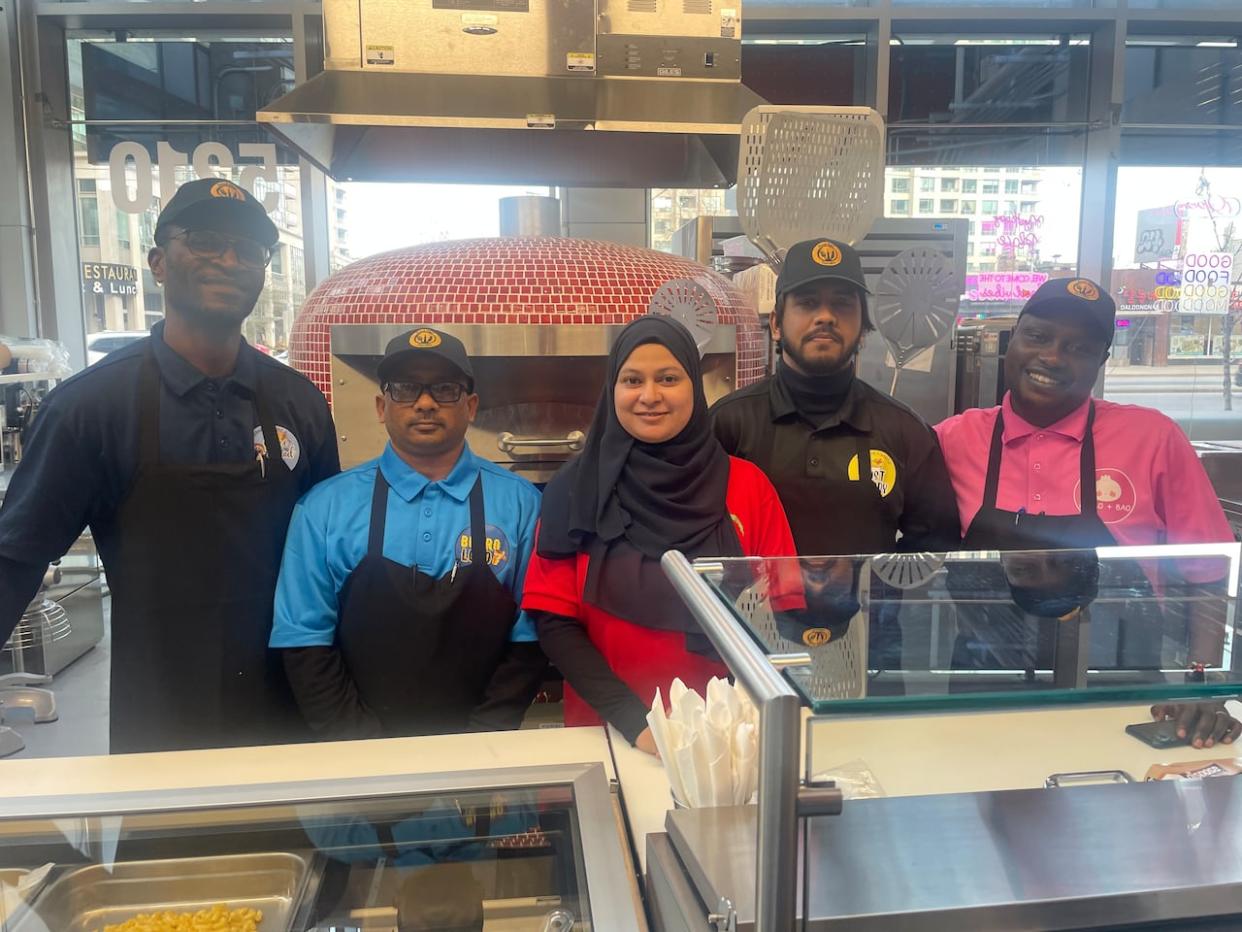 Food Hall TO's first five student entrepreneurs are being trained on everything from how to hold a knife properly to how to order supplies and price food, all while running their own kitchens. (Ethan Lang/CBC - image credit)