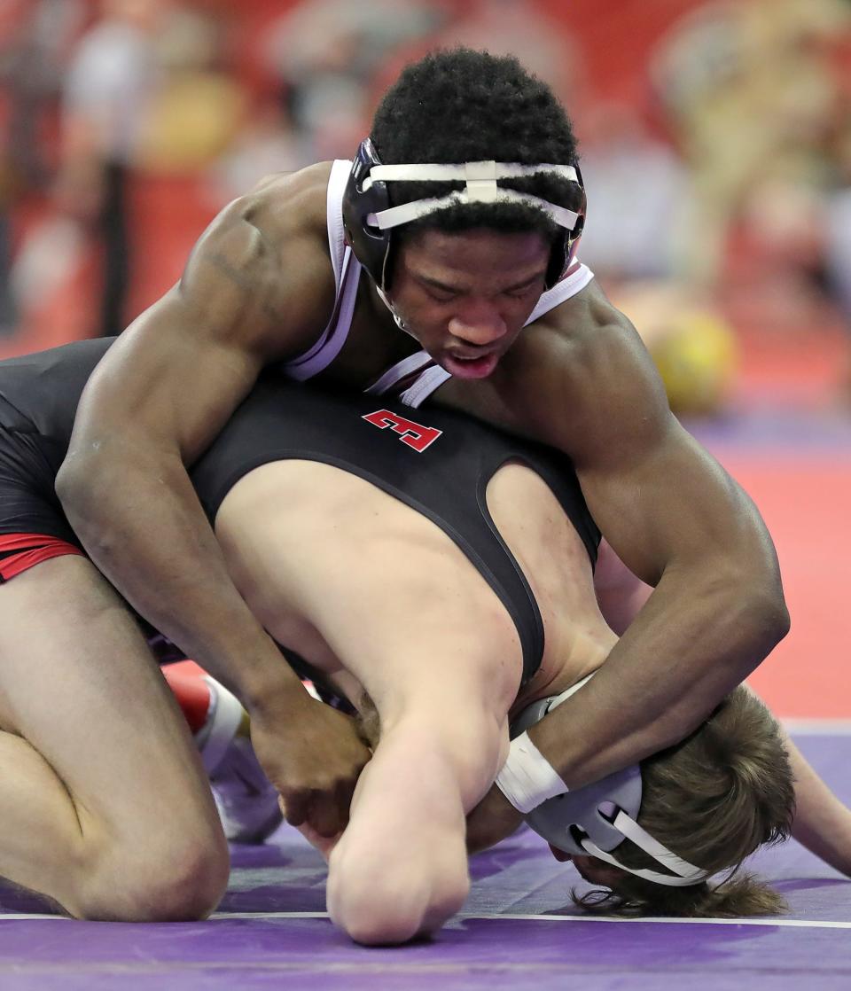 Walsh Jesuit's Dy'Vaire VanDyke works over Elyria's Nate Burnett during their 138-pound match in the Division I semifinal round of the State Wrestling Tournament on Saturday at the Schottenstein Center. [Jeff Lange/Beacon Journal]