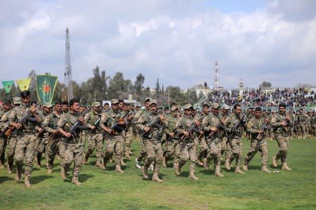 FILE PHOTO: Kurdish fighters from the People's Protection Units (YPG) take part in a military parade as they celebrate victory over the Islamic state, in Qamishli