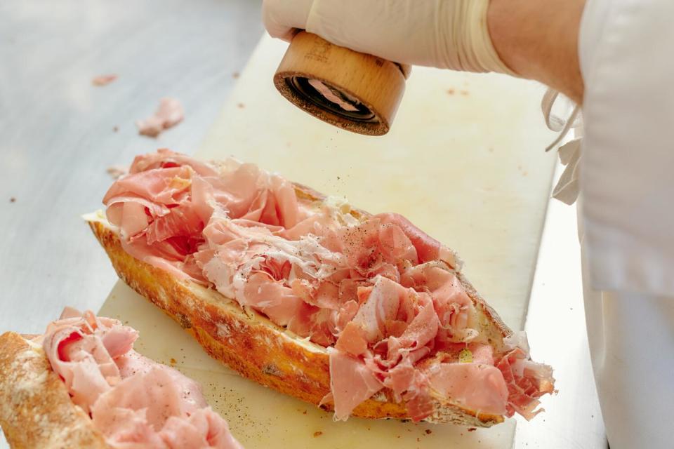 Chef Daniel Matho prepares one of his baguette sandwiches at Maison Matho.