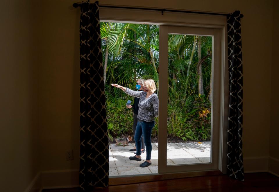 The Landmark Group realtor Deidre Newton, back, shows a home for sale to real estate investor Deirdre Oren Byrne in West Palm Beach, Florida on April 3, 2021.