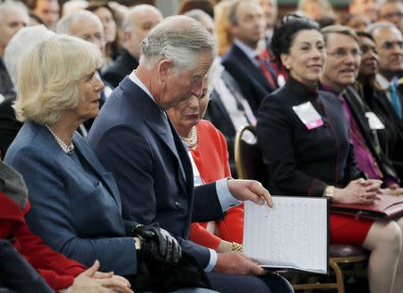 Britain's Prince Charles (C) looks over the musical score to "Kentucky Royal Fanfare" at the Kentucky Center for African American Heritage in Louisville, Kentucky March 20, 2015. REUTERS/John Sommers II