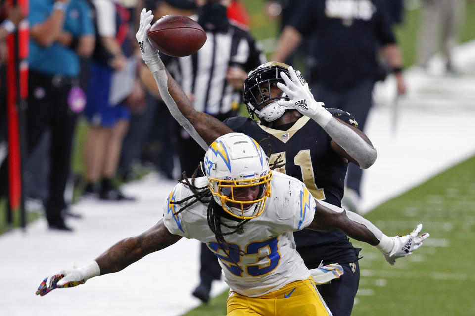 New Orleans Saints running back Alvin Kamara (41) pulls in a pass over Los Angeles Chargers strong safety Rayshawn Jenkins (23), setting up a touchdown, in the second half of an NFL football game in New Orleans, Monday, Oct. 12, 2020. The Saints won in overtime, 30-27. (AP Photo/Butch Dill)