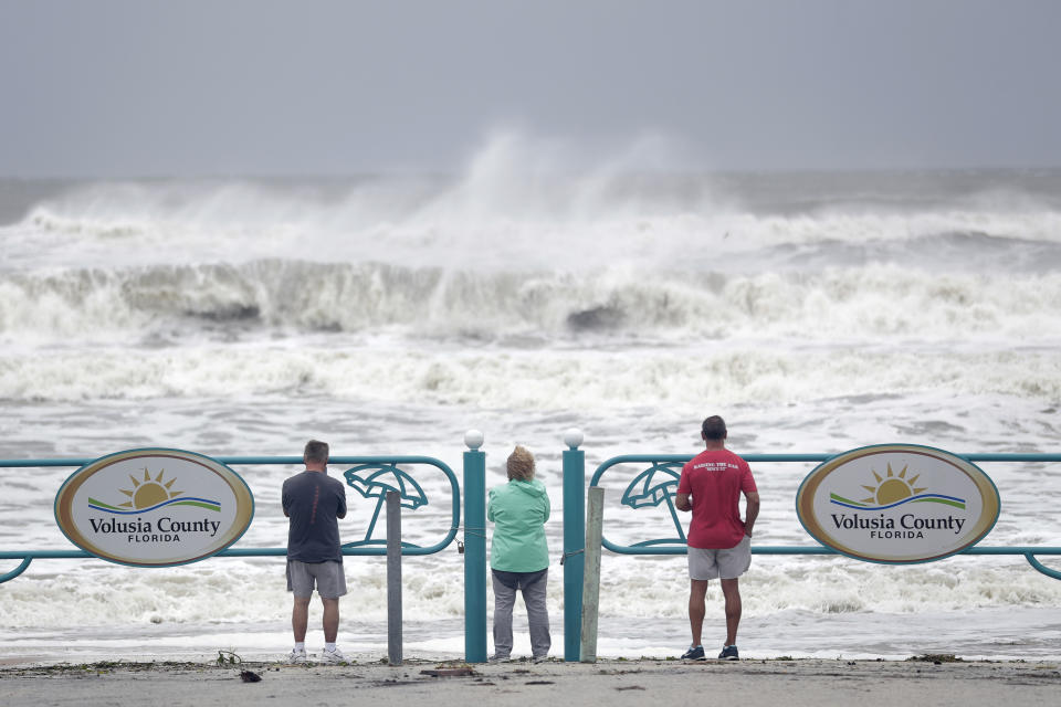 Sightseers watch waves crash on shore as Hurricane Dorian made it's way off the Florida coast Wednesday, Sept. 4, 2019, in Ormond Beach, Fla. (Photo: John Raoux/AP)