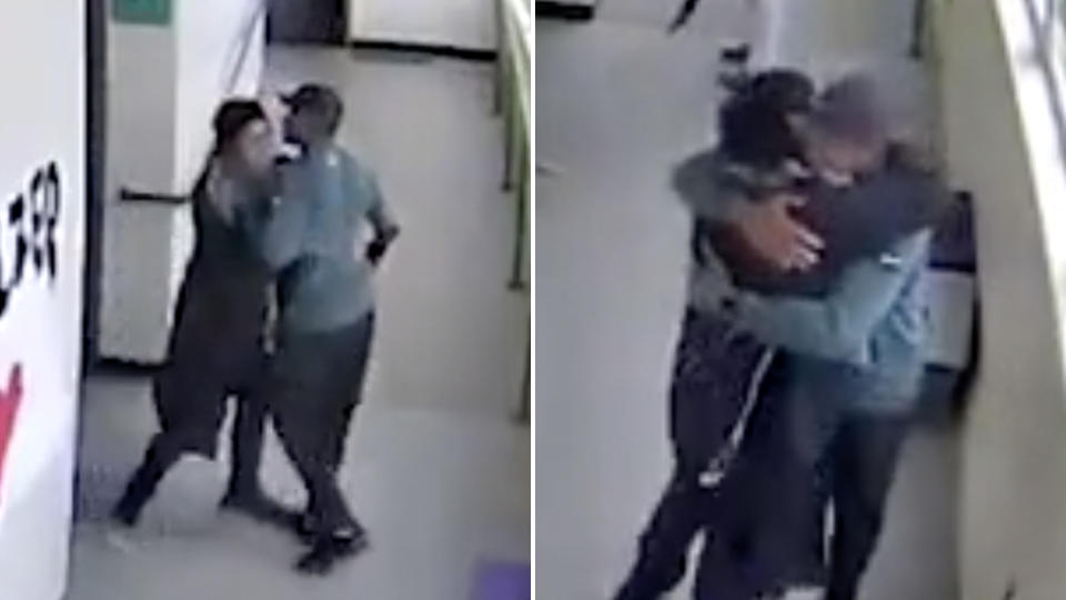 Picture of Keanon Lowe, the high school football coach and Angel Granados Dias, in the school hallway at the coach takes the gun away from the student and hugs him