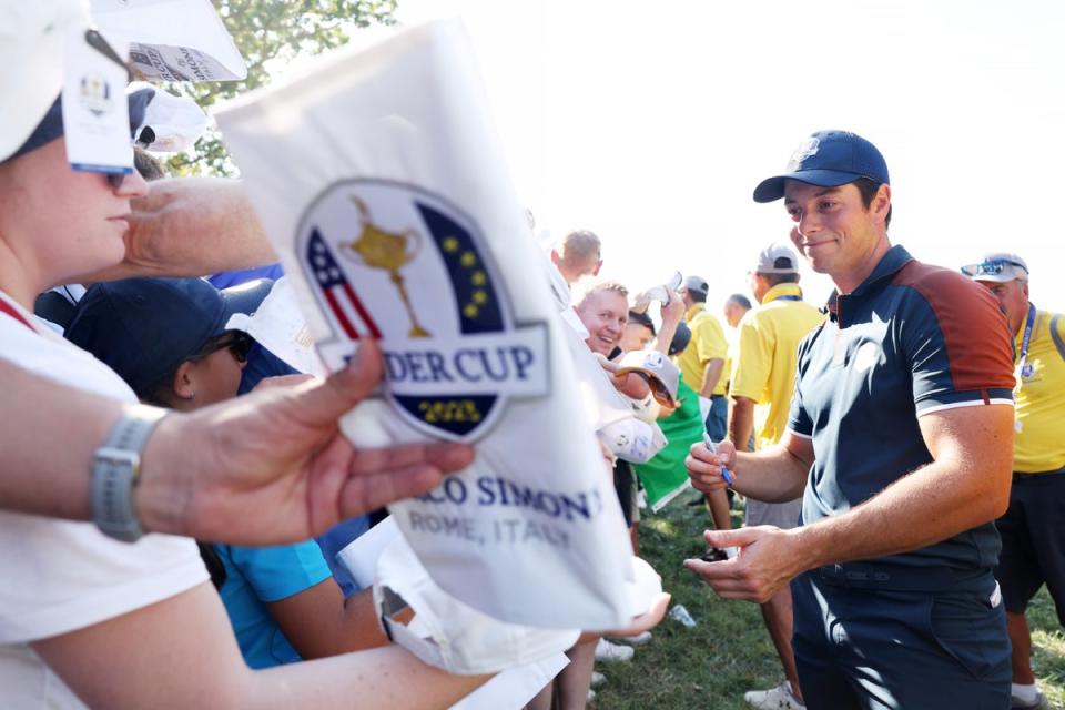 Viktor Hovland signs memorabilia for fans during Thursday’s final practice round (Getty Images)