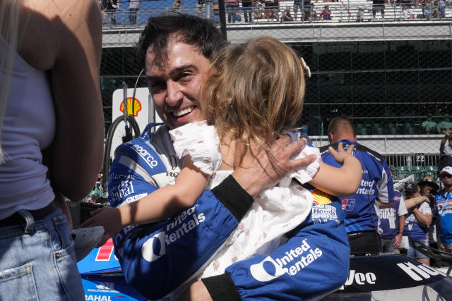 Graham Rahal hugs his daughter Harlan Ann, after he failed to make the field for the race during qualifications for the Indianapolis 500 auto race at Indianapolis Motor Speedway in Indianapolis, Sunday, May 21, 2023. (AP Photo/Michael Conroy)