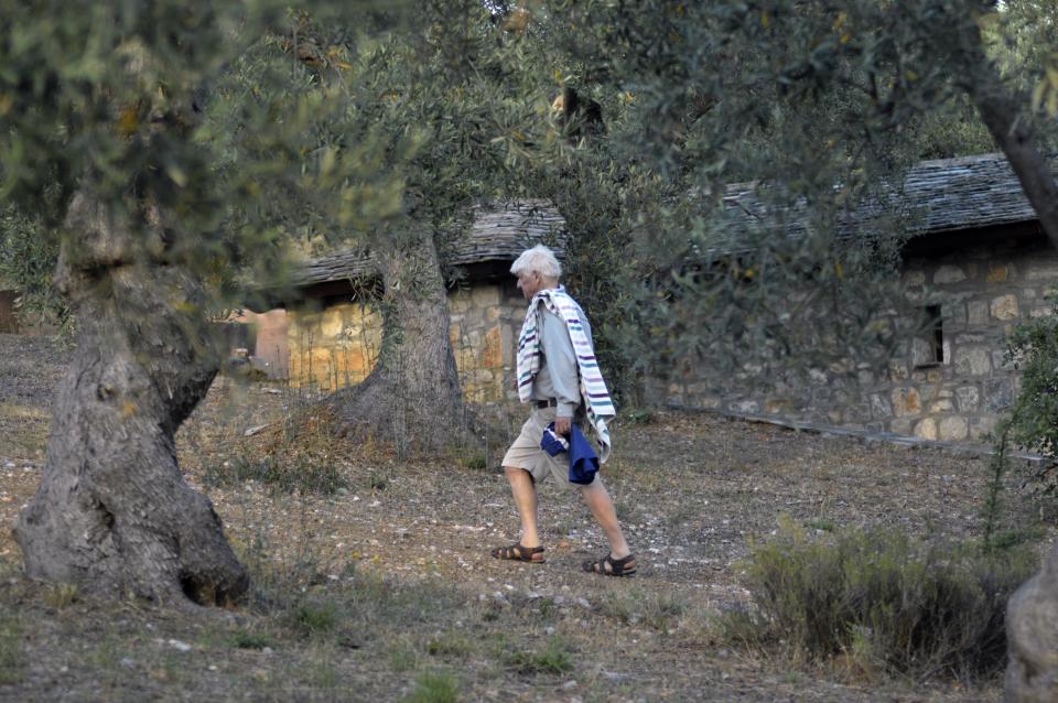 Stanley Johnson, father of Britain's Prime Minister Boris Johnson, walks, outside his Villa Irene in Horto village, Mount Pelion (also known as Pilio), central Greece, Friday, July 3, 2020. Johnson arrived in Athens on Wednesday evening after flying via Bulgaria due to a current ban on direct flights from the Britain, before visiting his villa on Mount Pelion. (Dimitris Kareklidis/magnesianews.gr via AP)