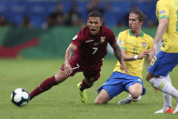 Venezuela's Darwin Machis, left, reacts next to Brazil's Filipe Luis during a Copa America Group A soccer match at the Arena Fonte Nova in Salvador, Brazil, Tuesday, June 18, 2019. (AP Photo/Natacha Pisarenko)