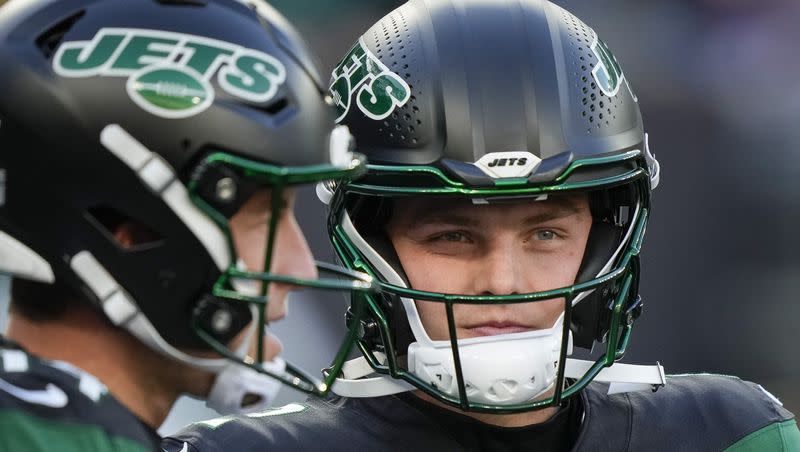 New York Jets quarterbacks Zach Wilson, right, and Trevor Siemian before a game between the New York Jets and the Miami Dolphins on Nov. 24, 2023, in East Rutherford, N.J. Rumors continue to swirl surrounding the embattled quarterback.