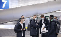 In this handout photo members of Bulgarian soccer team Ludogorets, wearing protective face masks arrive at Malpensa airport in Milan, Italy, Wednesday Feb. 26, 2020. Ludogorets arrived in Italy to play Italian club Inter Milan in a Europa League soccer match on Thursday that is scheduled to go ahead in an empty stadium due to the coronavirus outbreak.(Ludogorets FC via AP)