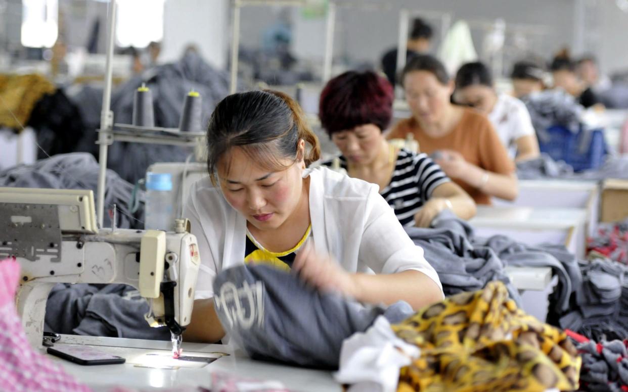 Employees working in a textile factory in Linyi in China's eastern Shandong province - STR/AFP/Getty Images