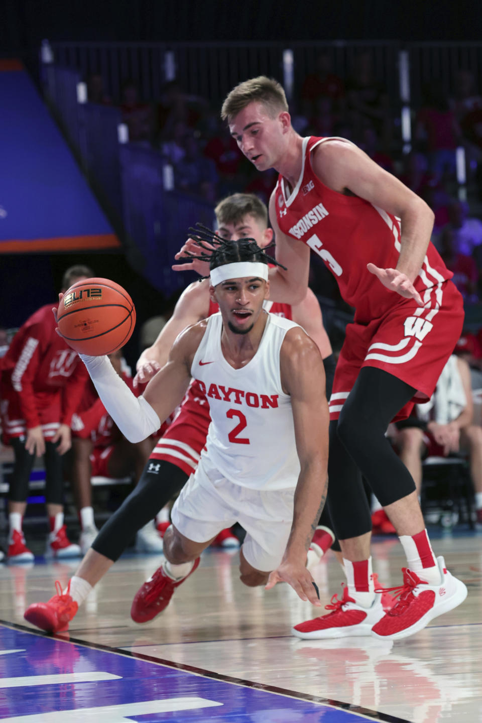 This photo provided by Bahamas Visual Services shows Dayton forward Toumani Camara being defended by Wisconsin forward Tyler Wahl (5) during an NCAA college basketball game at the Battle 4 Atlantis at Paradise Island, Bahamas, Wednesday, Nov. 23, 2022. . (Tim Aylen/Bahamas Visual Services via AP)