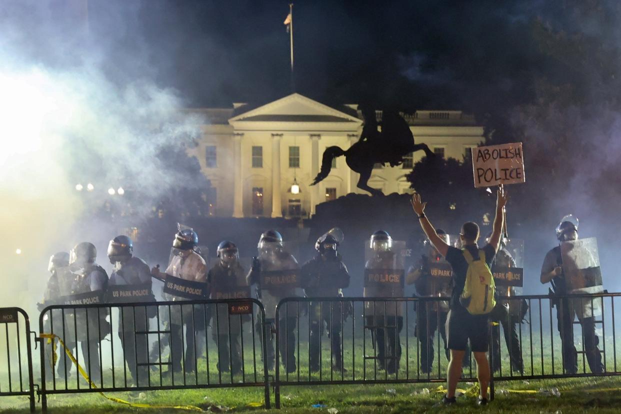 Police in riot gear stand between demonstrators and the White House during protests against law enforcement racism: REUTERS