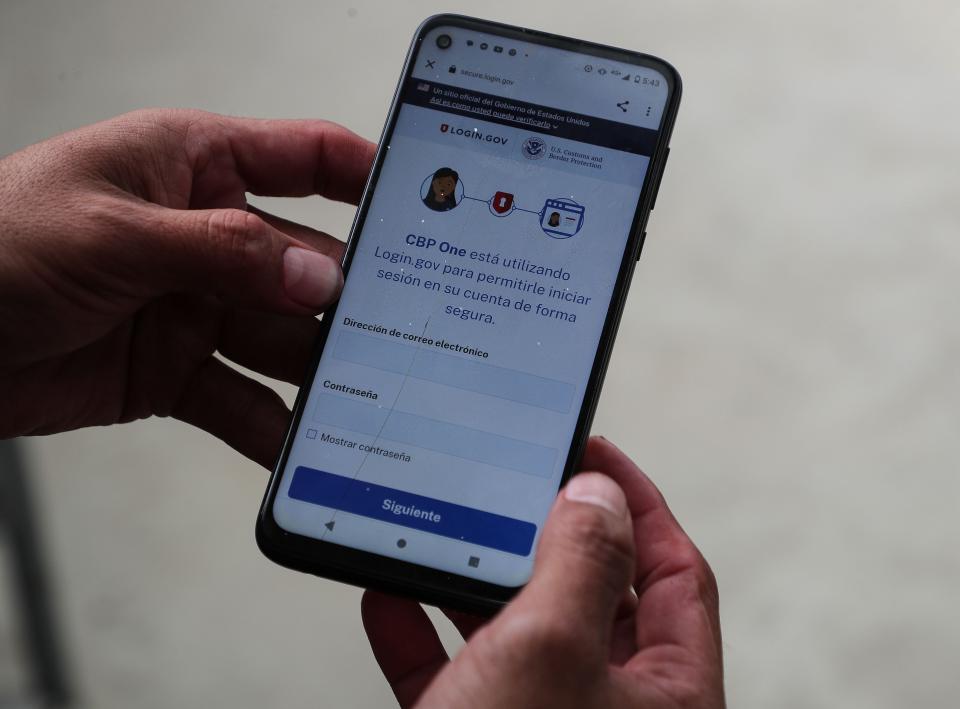 Erlin Rodriguez Nunez uses the CPB One App to try to navigate his family's immigration to the United States while staying at the Embajador de Jesus migrant shelter in the eastern part of Tijuana, Mexico, May 11, 2023.