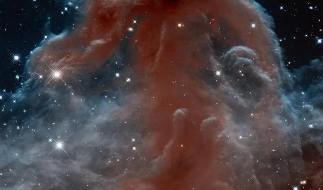 Clouds of Cosmic Dust Glow Near the Orion Nebula